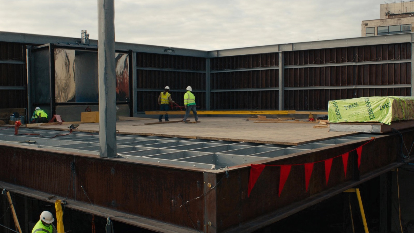 Construction crew working on steel framing at a job site